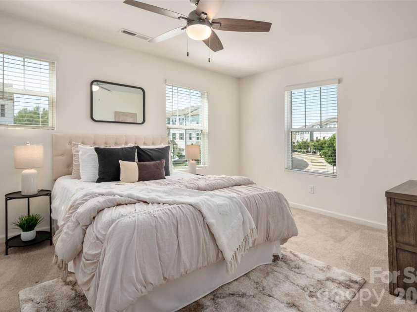 13205 Gadwal Pintail Drive, Charlotte, NC 28262.  MLS# CAR4380012, YatesRealty ID 27656. This spacious and peaceful primary bedroom  is the perfect place to relax after a long day.