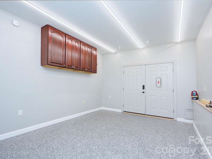 10209 Tallent Lane, Huntersville, NC 28078.  MLS# CAR4368648, YatesRealty ID 27661. Workshop in the basement with new epoxy floors