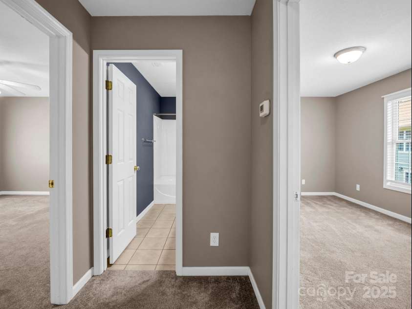 34 Douglas Fir Avenue, Arden, NC 28704.  MLS# CAR4275111, YatesRealty ID 27661. Second floor: Primary bedroom (left), full bathroom, 2nd  bedroom (right)