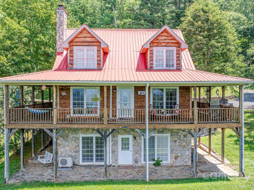 715 Sunset Mountain Road, Bakersville, NC 28705.  MLS# CAR4276207, YatesRealty ID 27672. Deck & stone patio wrap around 3 sides