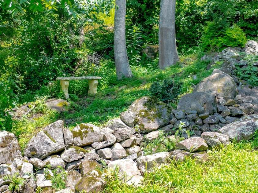 715 Sunset Mountain Road, Bakersville, NC 28705.  MLS# CAR4276207, YatesRealty ID 27672. Man made waterfall.