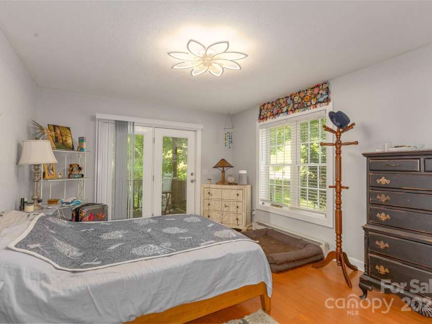 715 Sunset Mountain Road, Bakersville, NC 28705.  MLS# CAR4276207, YatesRealty ID 27672. Primary bedroom on main. French door opens onto side deck.