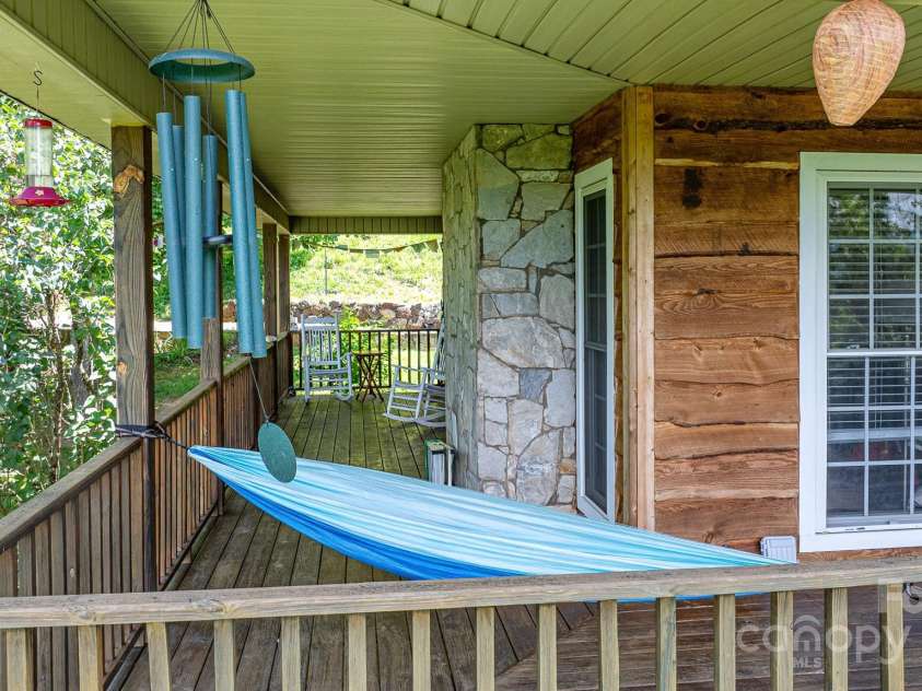 715 Sunset Mountain Road, Bakersville, NC 28705.  MLS# CAR4276207, YatesRealty ID 27672. Side deck leads to Frnech doors in primary bedroom.