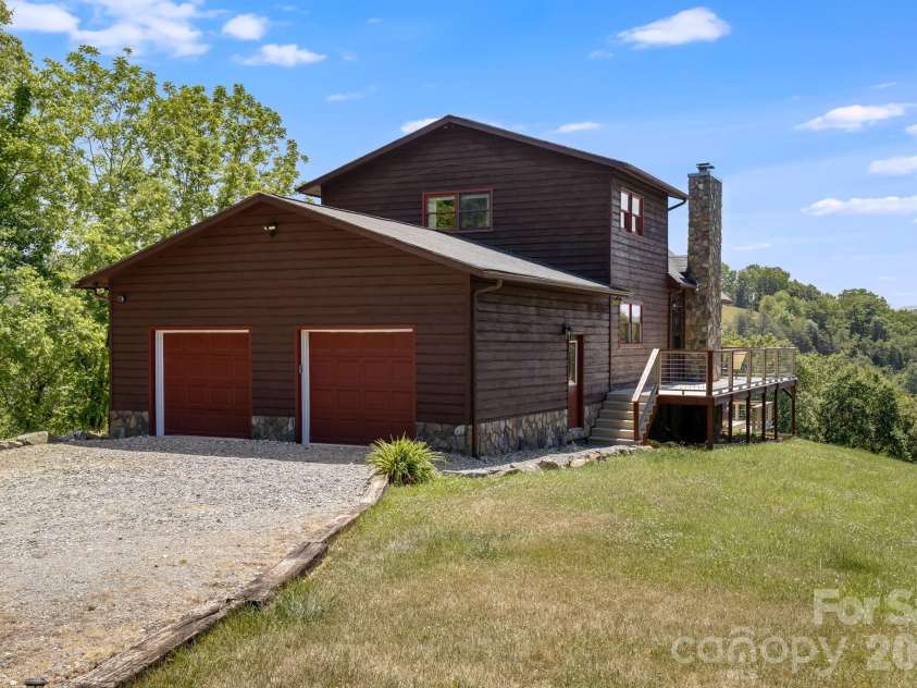 694 Boulder Road, Marshall, NC 28753.  MLS# CAR4384488, YatesRealty ID 27681. Back of home, large garage pictured