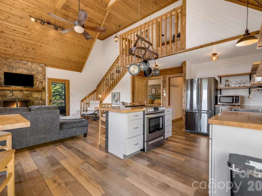694 Boulder Road, Marshall, NC 28753.  MLS# CAR4384488, YatesRealty ID 27681. View of Great room from kitchen. 
