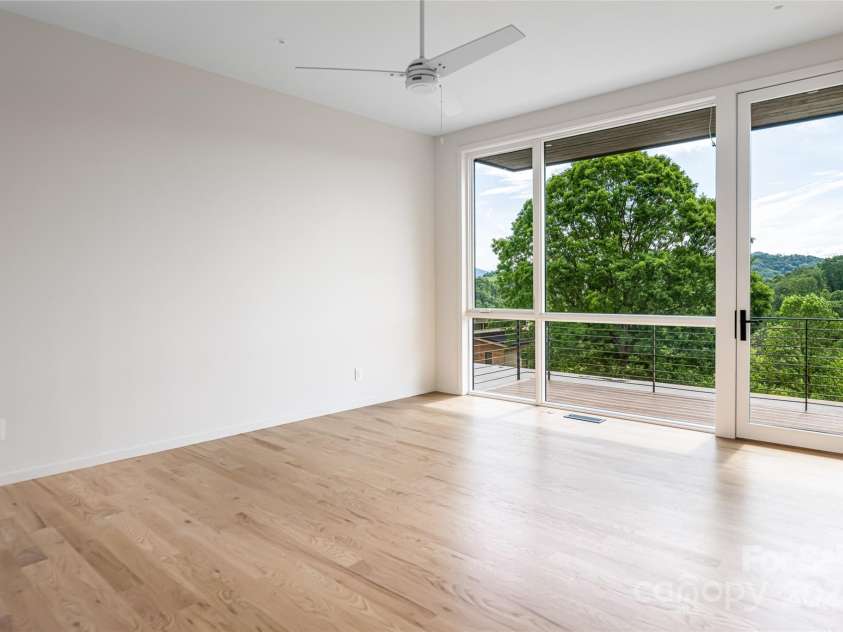 502 Wilma Dykeman Trail, Asheville, NC 28804.  MLS# CAR4271749, YatesRealty ID 27683. Sleek Primary Suite Features Private Balcony Access