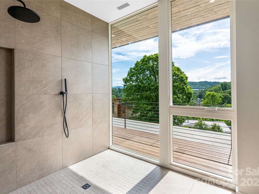 502 Wilma Dykeman Trail, Asheville, NC 28804.  MLS# CAR4271749, YatesRealty ID 27683. Zero-Entry Tiled Shower with a View