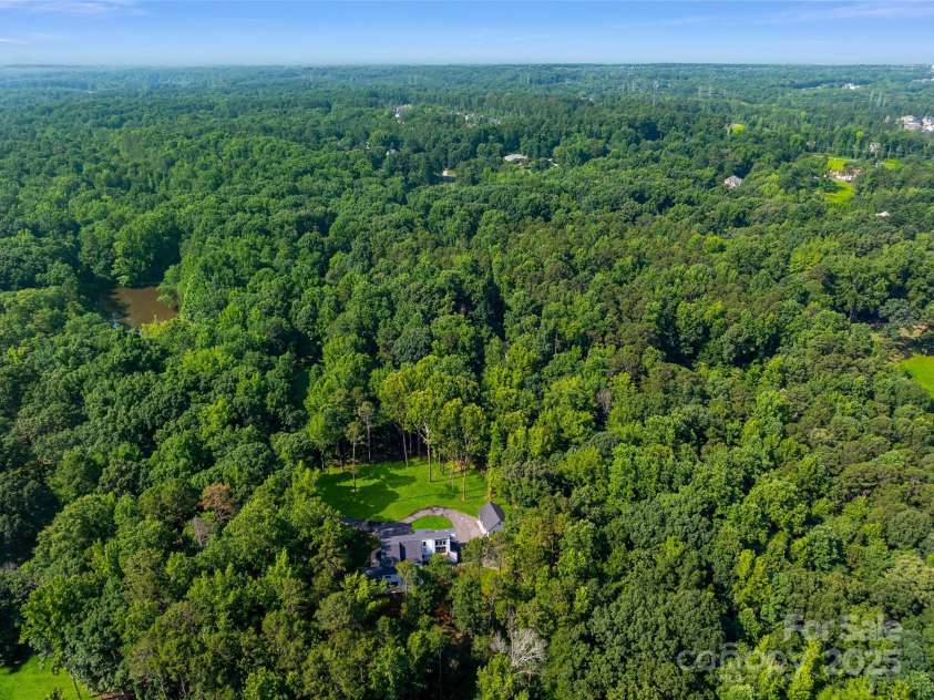 202 Walden Lane, Weddington, NC 28104.  MLS# CAR4274897, YatesRealty ID 27698. Aerial view with community pond