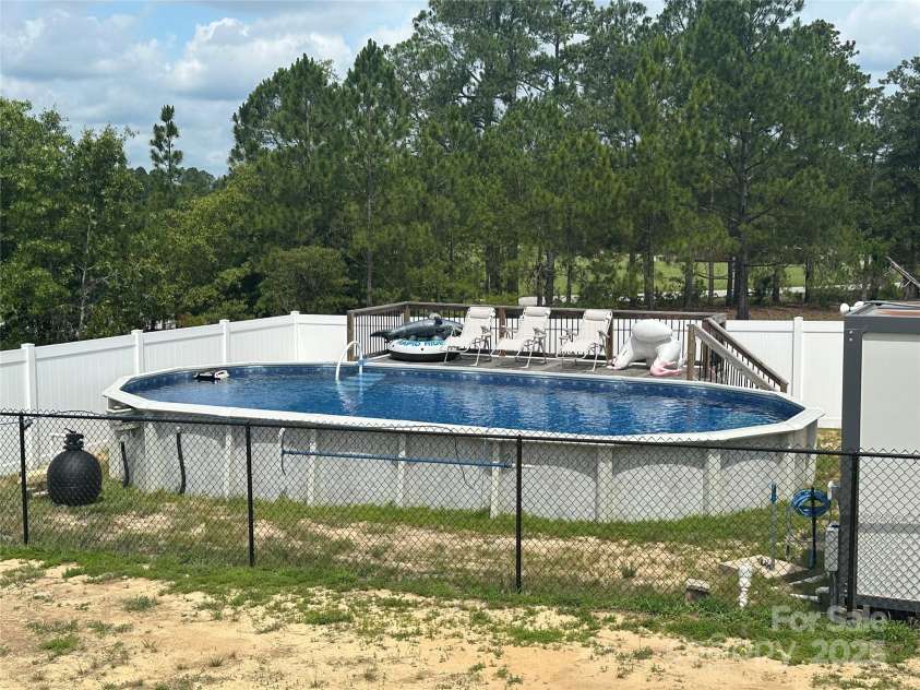 428 Long Branch Church Road, Jefferson, SC 29718.  MLS# CAR4270911, YatesRealty ID 27701. Above ground pool with deck and privacy fence.