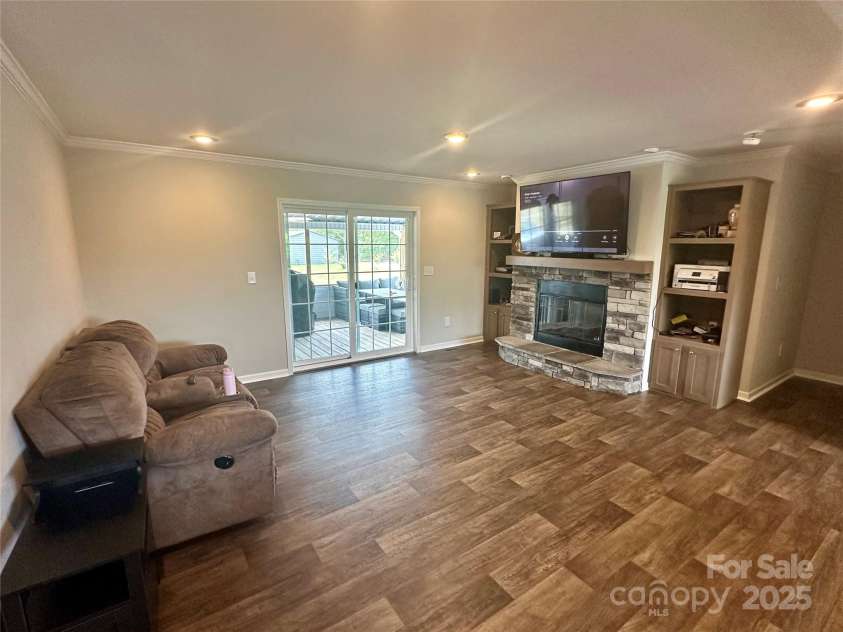 428 Long Branch Church Road, Jefferson, SC 29718.  MLS# CAR4270911, YatesRealty ID 27701. Den with FP leading to the rear screened deck