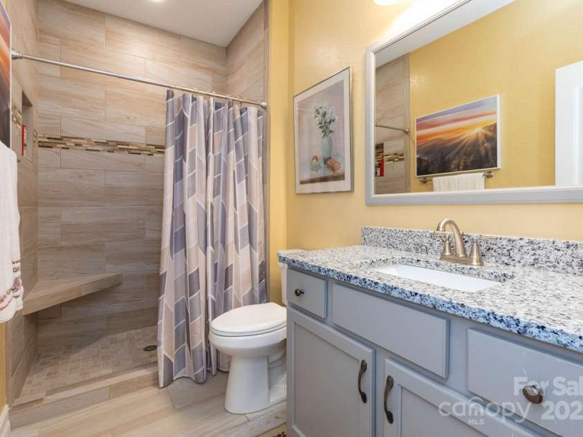 605 Red Bank Road, Waynesville, NC 28786.  MLS# CAR4277053, YatesRealty ID 27707. Guest bathroom features granite counters and tile shower