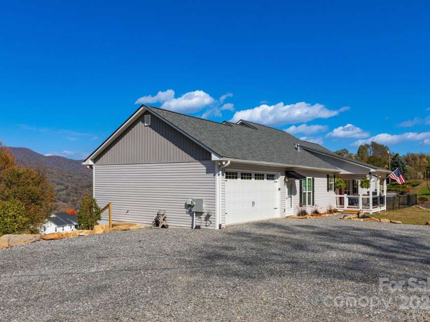 605 Red Bank Road, Waynesville, NC 28786.  MLS# CAR4313671, YatesRealty ID 27707. Garage side of home showing RV parking space with 220 v outlet