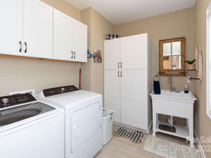 605 Red Bank Road, Waynesville, NC 28786.  MLS# CAR4313671, YatesRealty ID 27707. Huge laundry room featuring additional cabinets and sink