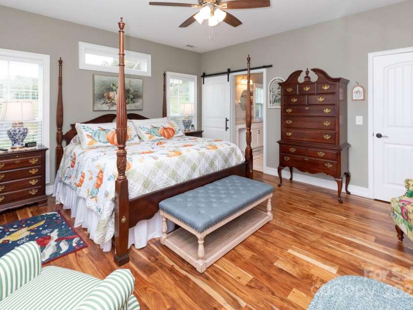 605 Red Bank Road, Waynesville, NC 28786.  MLS# CAR4313671, YatesRealty ID 27707. Primary bedroom with barn door leading to en suite bath and walk in closet