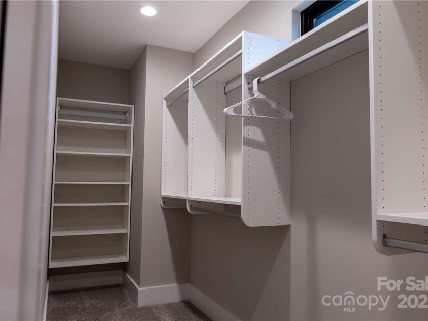 113 Angler Place, Mooresville, NC 28117.  MLS# CAR4217106, YatesRealty ID 2772. Large primary closet with custom shelving.