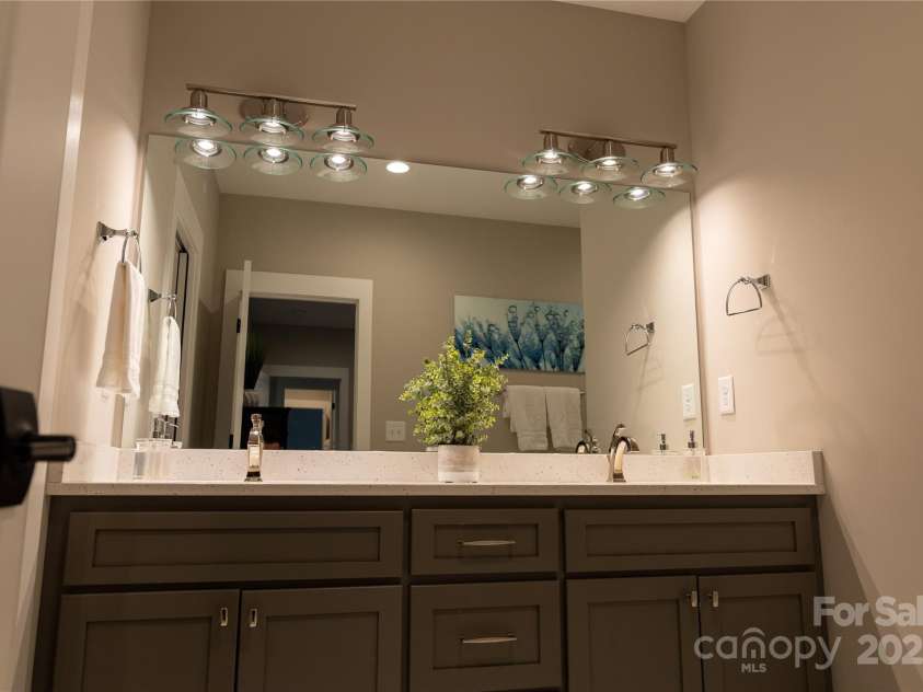 113 Angler Place, Mooresville, NC 28117.  MLS# CAR4217106, YatesRealty ID 2772. Primary bathroom with dual sinks and lovely lighting.