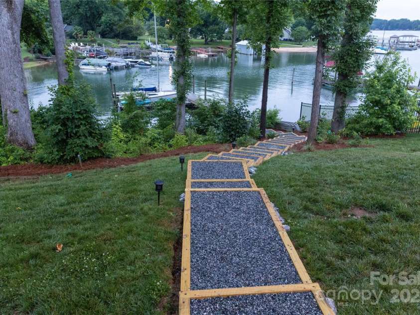 113 Angler Place, Mooresville, NC 28117.  MLS# CAR4217106, YatesRealty ID 2772. Walk the steps down to the dock and floating boat slip.