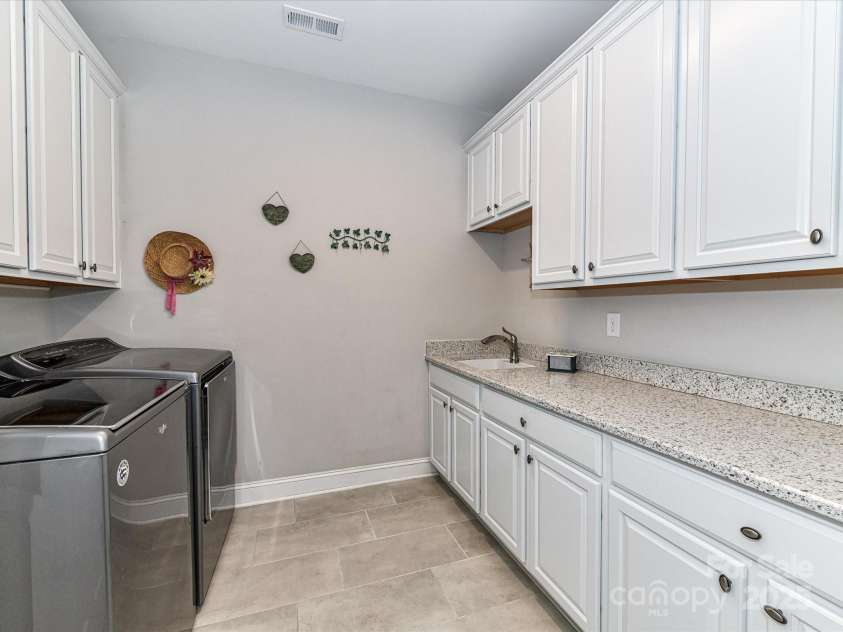 1805 Axholme Court, Waxhaw, NC 28173.  MLS# CAR4298904, YatesRealty ID 27747. Laundry on Main Level w/barn door, lots of cabinets & closet