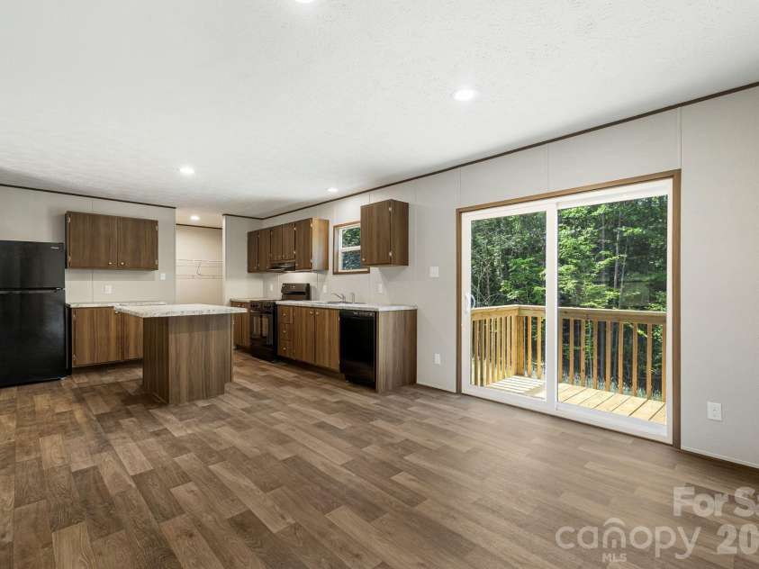 67 Vista Drive, Nebo, NC 28761.  MLS# CAR4389784, YatesRealty ID 27759. Sliding doors open to private back yard (over an acre!)
