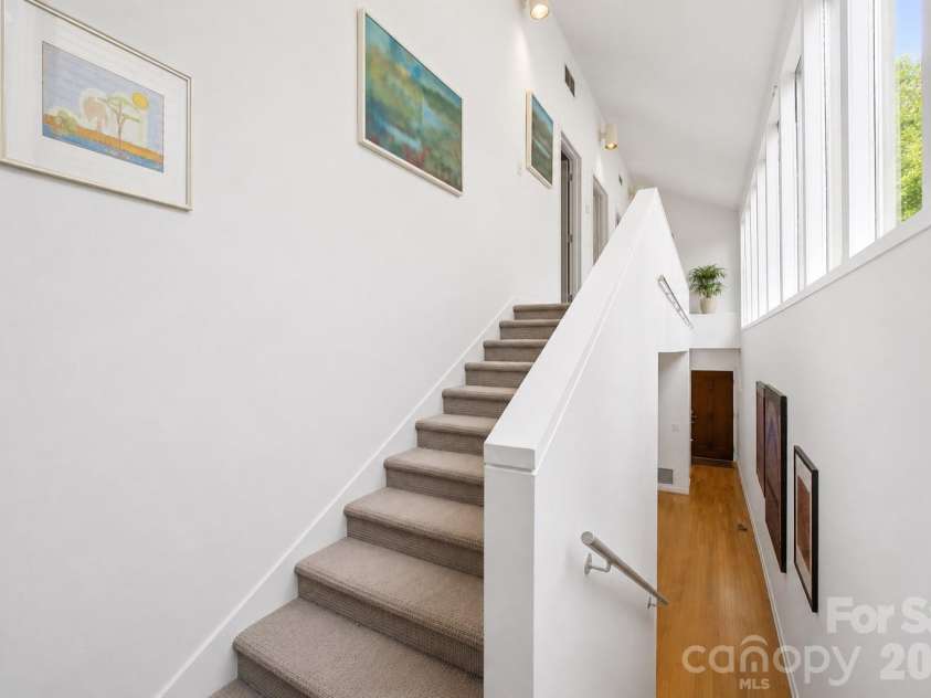 515 Poplar Street, Charlotte, NC 28202.  MLS# CAR4378649, YatesRealty ID 27783. Bright multi-level interior featuring soaring ceilings, expansive windows, and an open architectural staircase filled with natural light