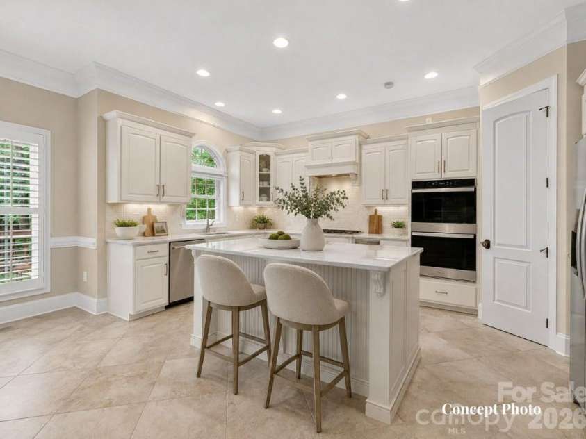 11615 Hidden Forest Lane, Davidson, NC 28036.  MLS# CAR4386264, YatesRealty ID 27816. Concept photo virtually staged/upgraded photo of chef’s kitchen showcases rich custom cabinetry, granite countertops, stainless steel appliances, a large center island, and an open layout designed for effortless en