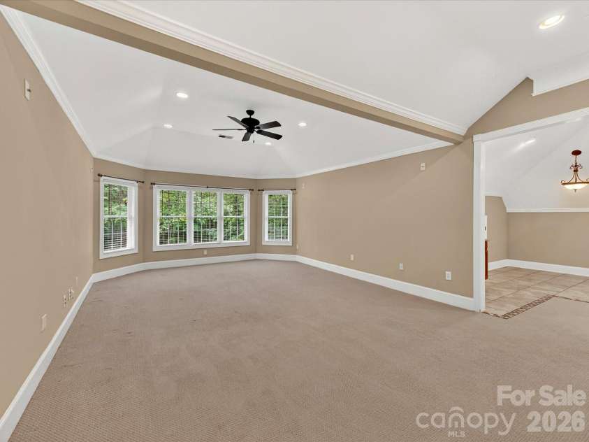 11615 Hidden Forest Lane, Davidson, NC 28036.  MLS# CAR4386264, YatesRealty ID 27816. Expansive third-level bonus room offers incredible flexibility with vaulted ceilings, recessed lighting, built-in wet bar, and abundant space for entertaining, recreation, or a home theater.