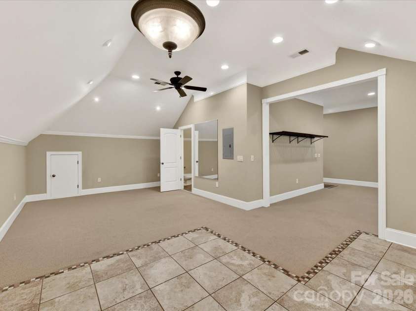 11615 Hidden Forest Lane, Davidson, NC 28036.  MLS# CAR4386264, YatesRealty ID 27816. Expansive third-level bonus room offers incredible flexibility with vaulted ceilings, recessed lighting, built-in wet bar, and abundant space for entertaining, recreation, or a home theater.