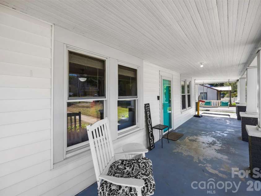 44 Dulin Drive, Concord, NC 28027.  MLS# CAR4376596, YatesRealty ID 27821. Rocking chair front porch
