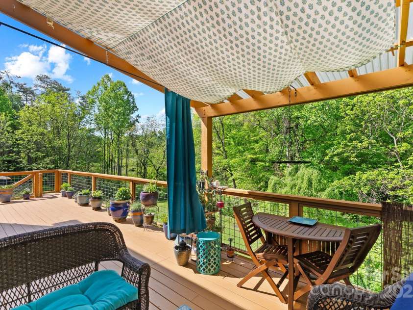 50 Pinerose Drive, Weaverville, NC 28787.  MLS# CAR4255853, YatesRealty ID 27829. Covered Outdoor Sitting Area w/Peaceful Wooded Backyard View