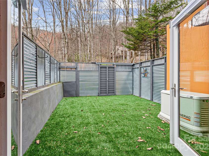 1585 Eagles Nest Road, Waynesville, NC 28786.  MLS# CAR4171726, YatesRealty ID 27848. Backyard from door