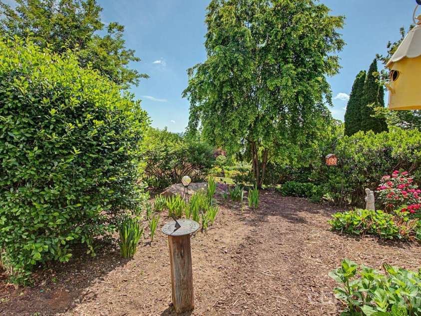 606 Carriage Commons Drive, Hendersonville, NC 28791.  MLS# CAR4386176, YatesRealty ID 27849. Beautiful well Established Gardens 