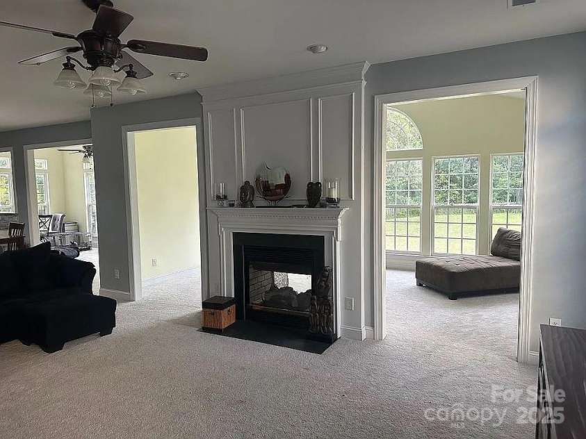 219 Flowering Grove Lane, Mooresville, NC 28115.  MLS# CAR4275731, YatesRealty ID 27853. Double sided Gas Fireplace sunroom/Great room