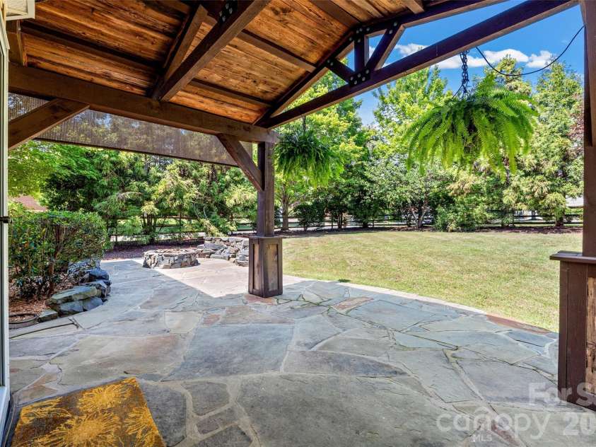 9118 Spratt Lane, Waxhaw, NC 28173.  MLS# CAR4416867, YatesRealty ID 27872. Covered Stone Patio