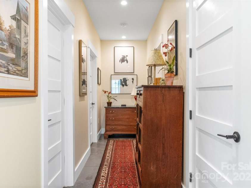 6 Houston Street, Asheville, NC 28801.  MLS# CAR4221476, YatesRealty ID 27884. Lower level hall to bedroom and bathroom