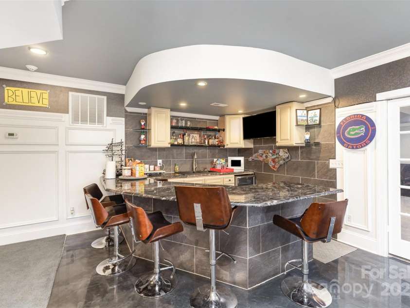 717 Barossa Valley Drive, Concord, NC 28027.  MLS# CAR4238339, YatesRealty ID 27886. Built in kitchen/bar area in basement