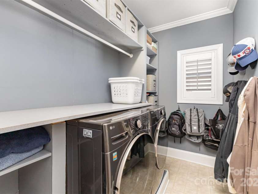 717 Barossa Valley Drive, Concord, NC 28027.  MLS# CAR4238339, YatesRealty ID 27886. Laundry room on main floor with shelving