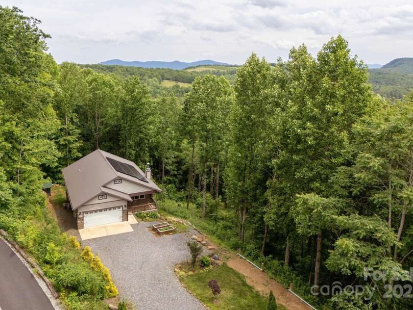 264 Splitrail Drive, Hendersonville, NC 28792.  MLS# CAR4260165, YatesRealty ID 27894. Escape to your dream mountain retreat in beautiful Hendersonville! Nestled on a serene, wooded lot, this stunning craftsman-style home offers the perfect blend of rustic charm and modern efficiency—complete with s