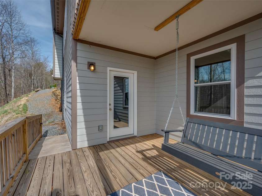 264 Splitrail Drive, Hendersonville, NC 28792.  MLS# CAR4260165, YatesRealty ID 27894. Rocking Chair covered porch on lower level.