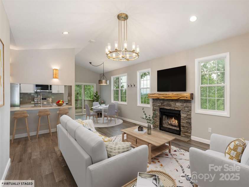 264 Splitrail Drive, Hendersonville, NC 28792.  MLS# CAR4260165, YatesRealty ID 27894. Virtually staged to highlight its potential, this bright and inviting living room features an open-concept layout, cozy fireplace with rustic mantle, and abundant natural light. The space flows seamlessly into the