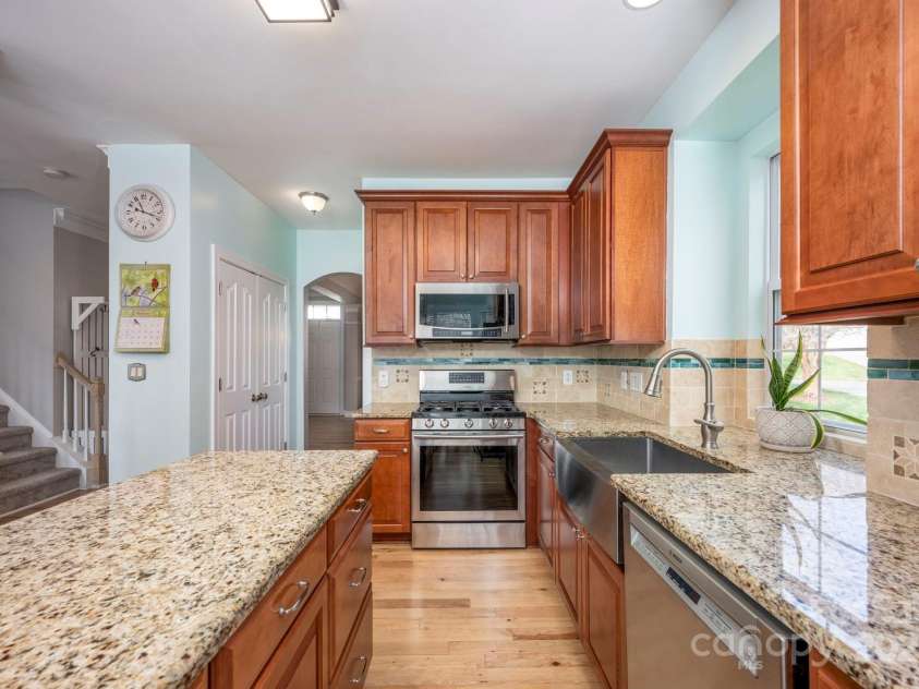 3329 Brownes Creek Road, Charlotte, NC 28269.  MLS# CAR4232626, YatesRealty ID 2790. Kitchen with pantry to the left and laundry room to the right behind the stove