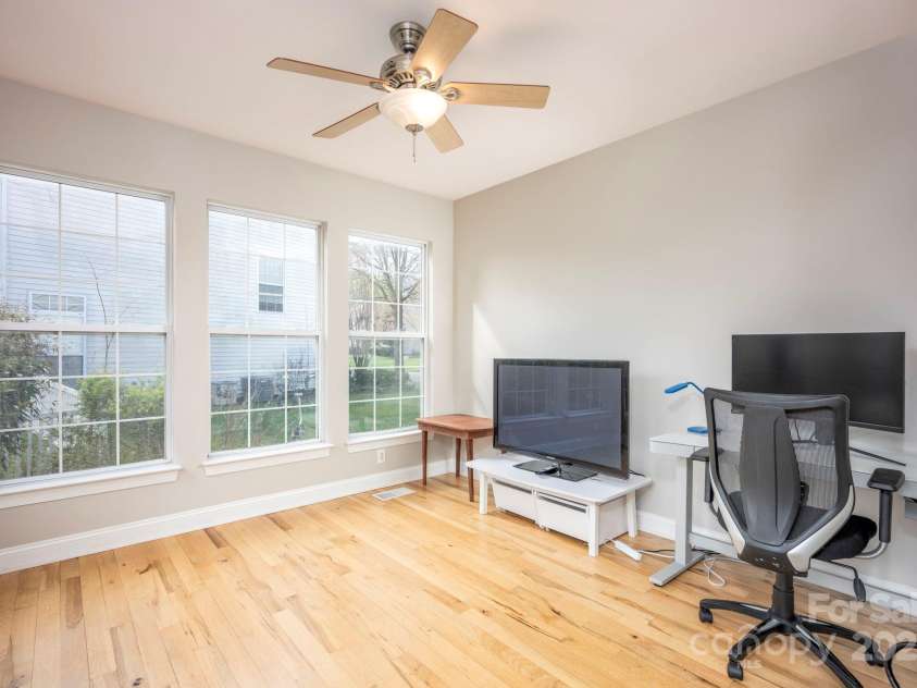 3329 Brownes Creek Road, Charlotte, NC 28269.  MLS# CAR4232626, YatesRealty ID 2790. Sunroom with ceiling fan and hardwood floors