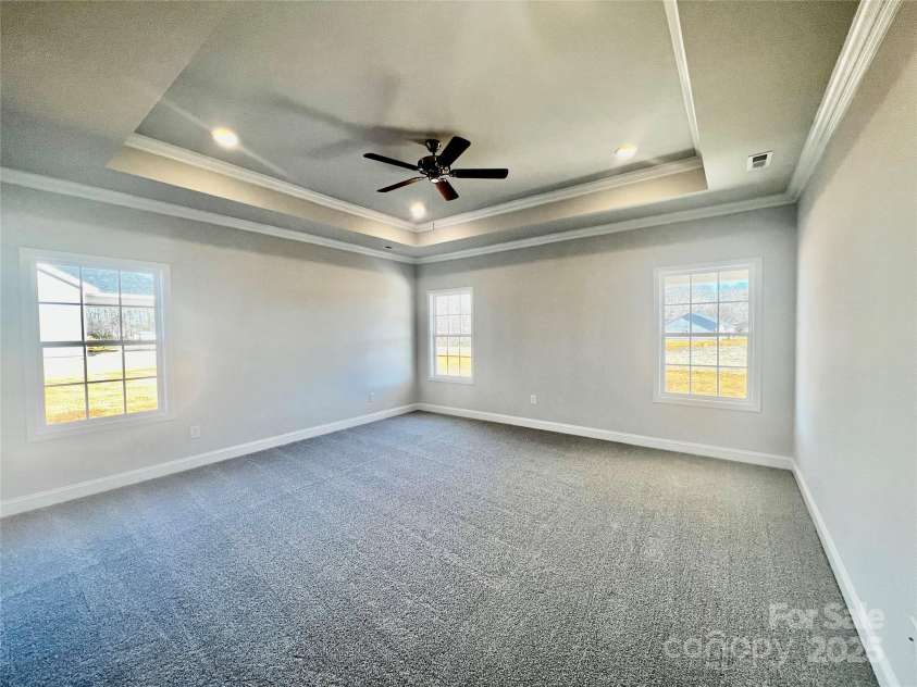 140 Swan Park Lane, Statesville, NC 28625.  MLS# CAR4284511, YatesRealty ID 27912. Primary bedroom with tray ceilings