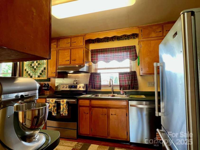 795 Monte Vista Road, Candler, NC 28715.  MLS# CAR4273590, YatesRealty ID 27916. Plenty of cabinets made of real wood.