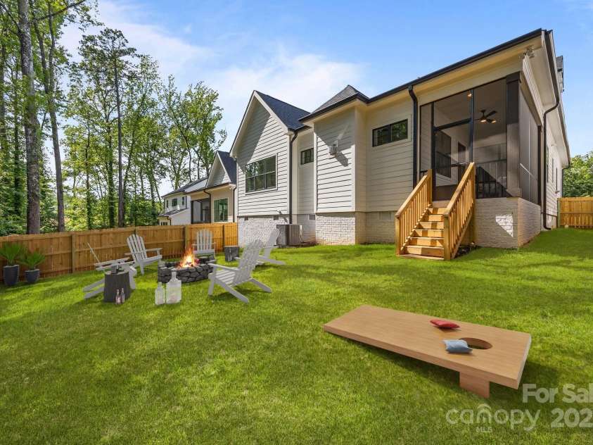 3945 Plainview Road, Charlotte, NC 28208.  MLS# CAR4273445, YatesRealty ID 27929. Virtually enhanced to show potential with greener lawn, corn hole setup, and fire pit.