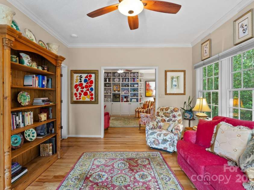 113 Fox Cross Drive, Brevard, NC 28712.  MLS# CAR4283870, YatesRealty ID 27930. Sunroom open from living area - lots of windows and hardwood floors