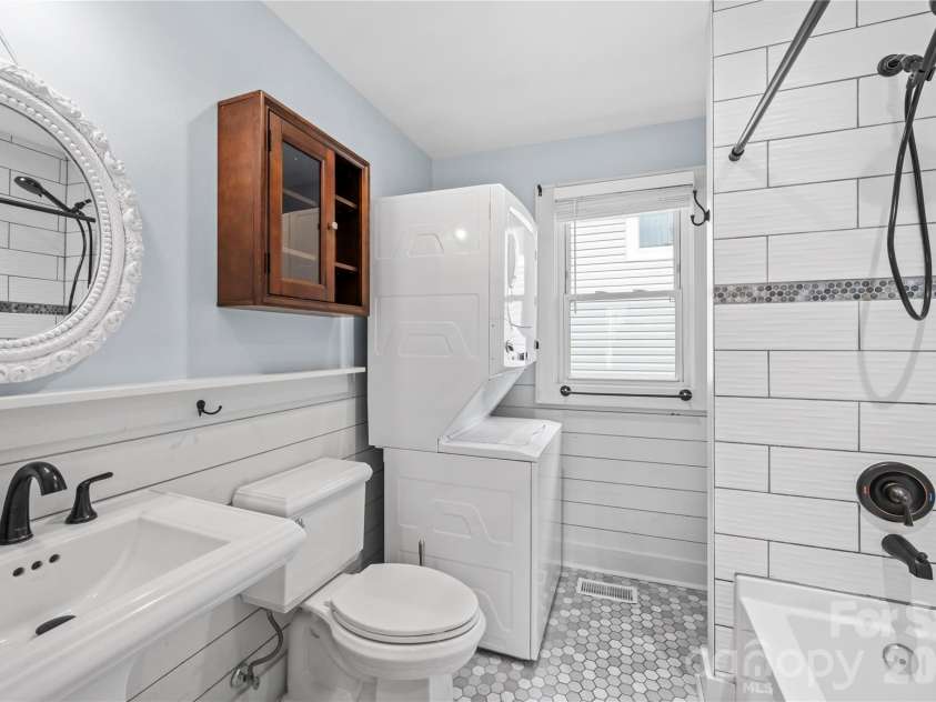 130 Winston Avenue, Asheville, NC 28803.  MLS# CAR4385170, YatesRealty ID 27944. Bright updated bathroom includes stack w/d unit