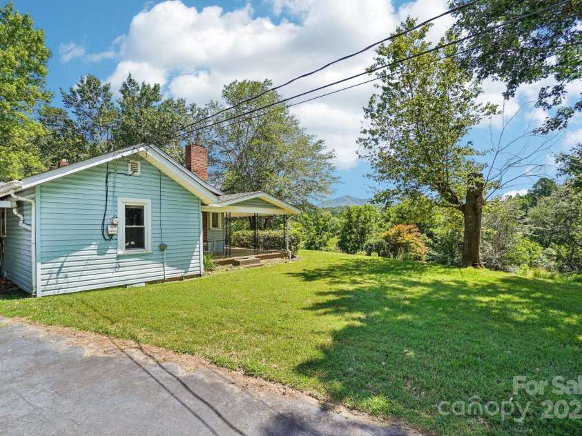 203 Beaverdam Road, Candler, NC 28715.  MLS# CAR4282589, YatesRealty ID 27973. Approach to carport via driveway