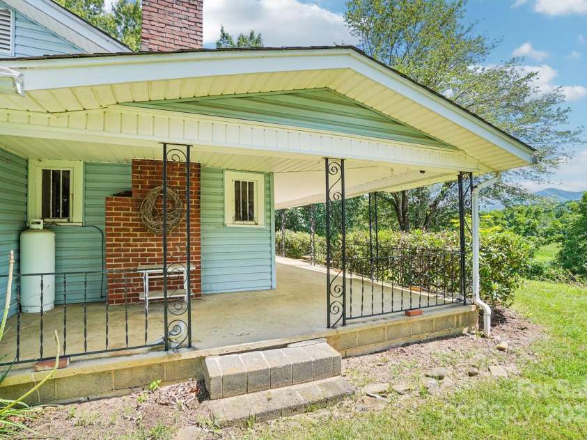 203 Beaverdam Road, Candler, NC 28715.  MLS# CAR4282589, YatesRealty ID 27973. Side porch