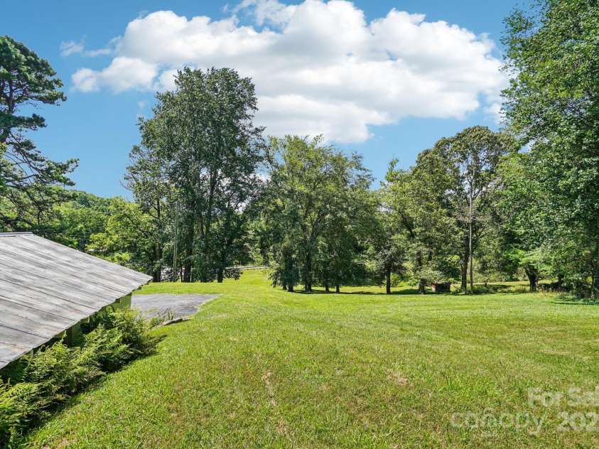 203 Beaverdam Road, Candler, NC 28715.  MLS# CAR4282589, YatesRealty ID 27973. Side yard, adjacent to garage.