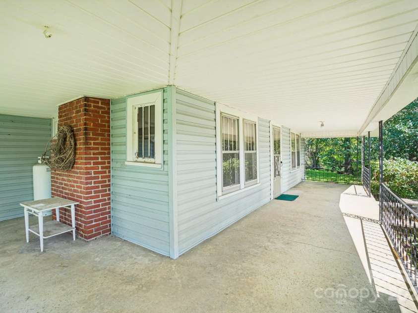 203 Beaverdam Road, Candler, NC 28715.  MLS# CAR4282589, YatesRealty ID 27973. Wrap around porch